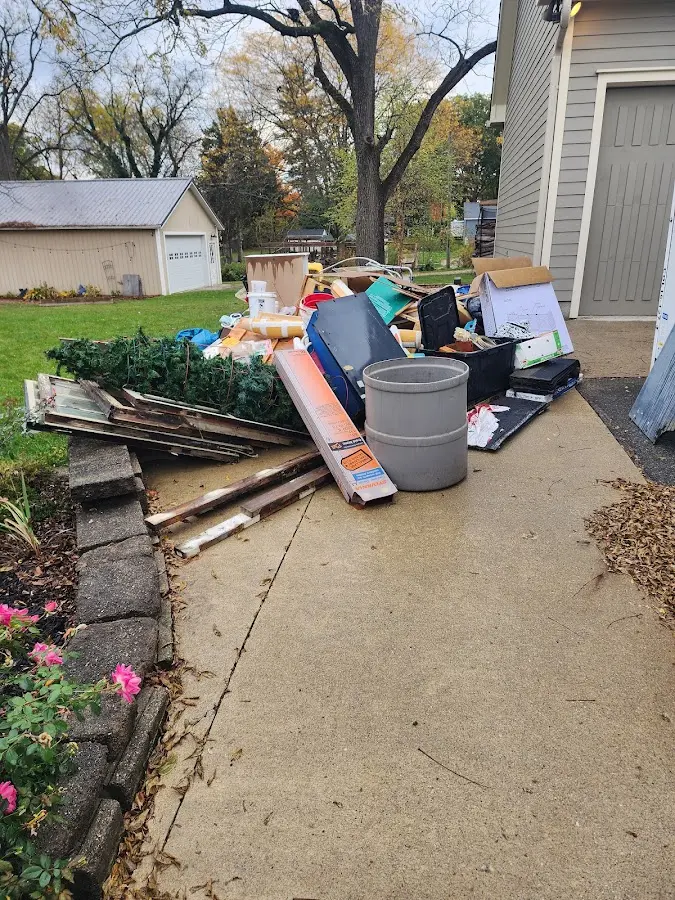 Dumpster being loaded with debris for Residential Dumpster Rental in Roanoke Rapids